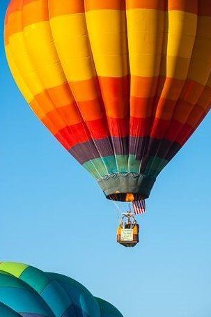 A multicolored hot air balloon in the sky.