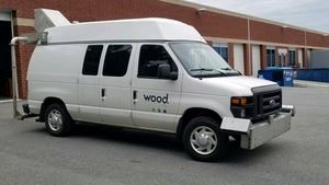 A white van with digital image collection equipment on the front and back.